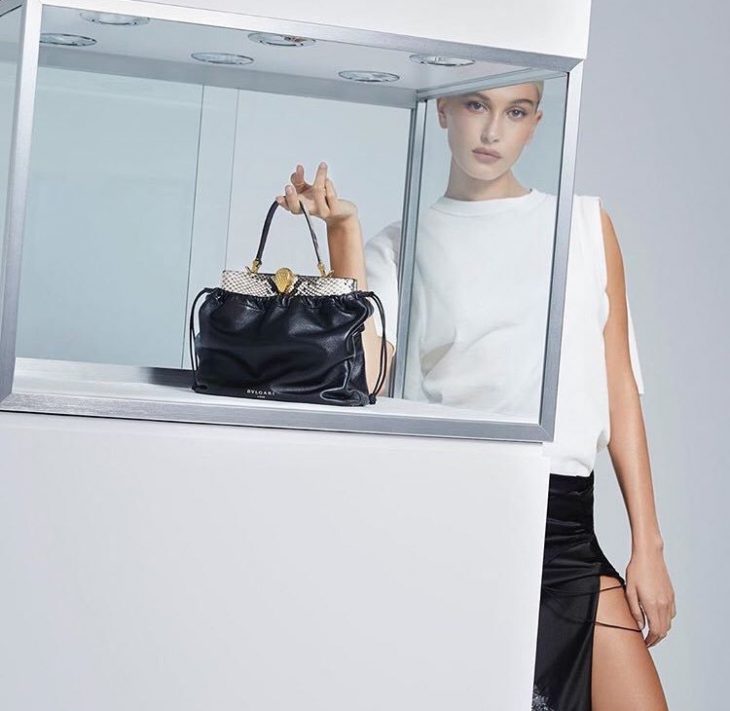 Hailey Bieber models the Bulgari x Alexander Wang handbag